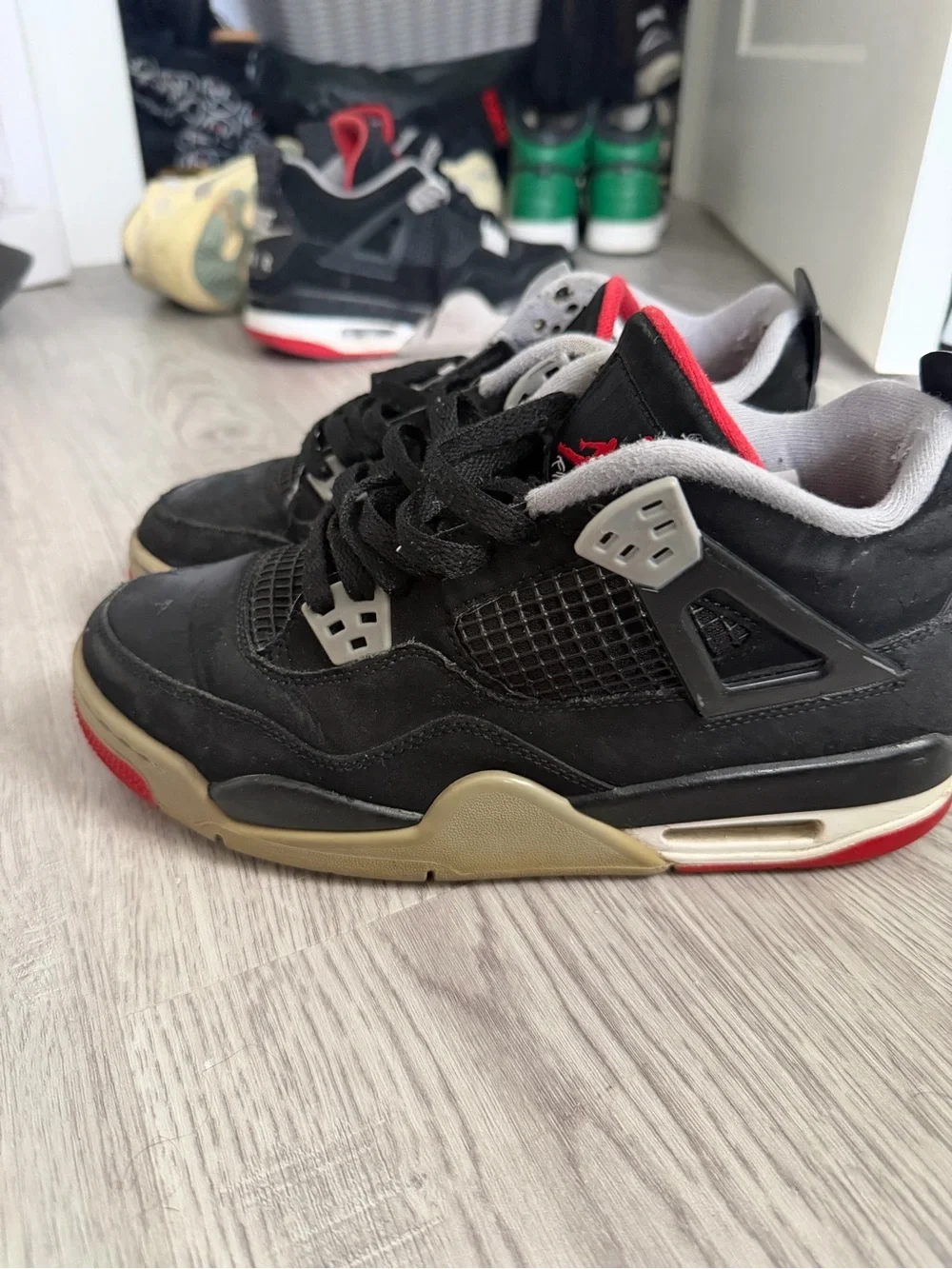 Jordan Men’s Black and Bred 4s Red Retro Basketball Sneakers with Cream Midsole